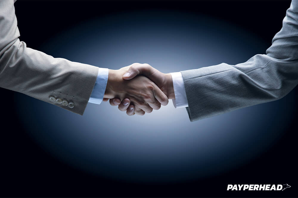 Two per head bookie agents shaking hands over layoff account concept